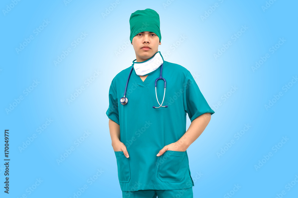 Asian smart doctor wearing green uniform and medical face mask with stethoscope. Isolated on blue background. Asian smart doctor wearing green uniform and medical face mask with stethoscope. Isolated on blue background.