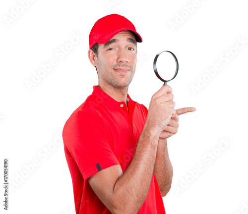 Happy delivery man using a magnifying glass © agongallud