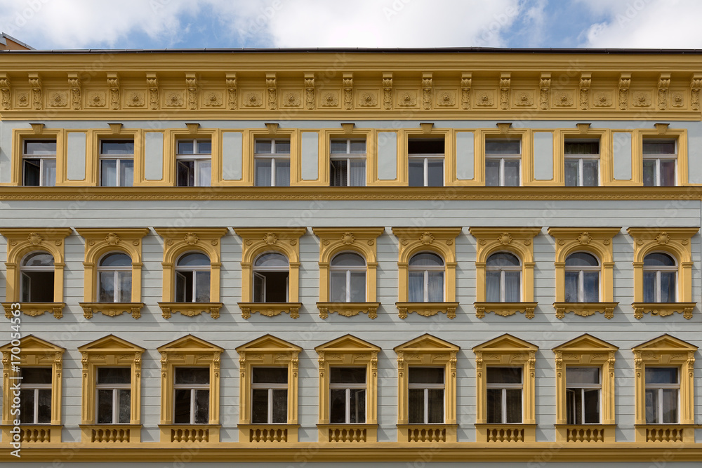 Facade of a building, windows, yellow walls