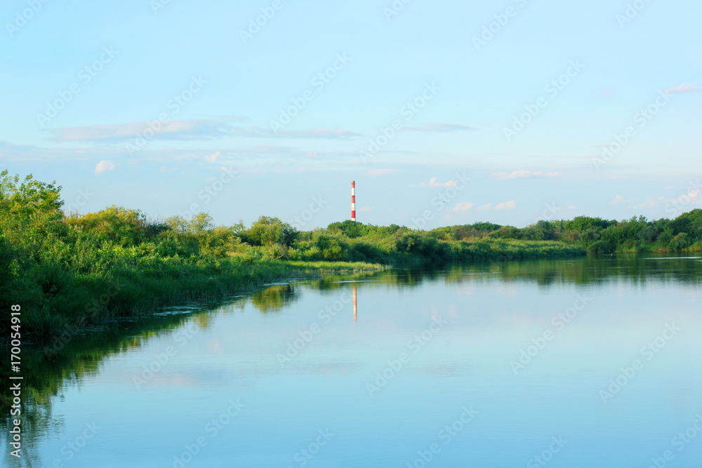 River, Bank and factory chimney in the distance