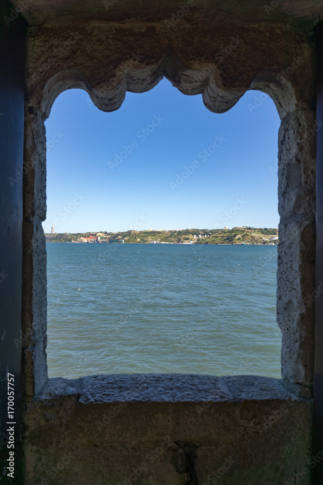 View through stone window across River Tagus, Lisbon