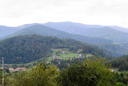 Fototapeta Naklejka Na Ścianę i Meble -  Landscape village among the forest high in the mountains