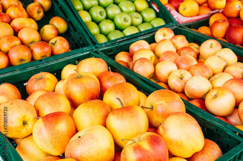 some red and green apples in boxes