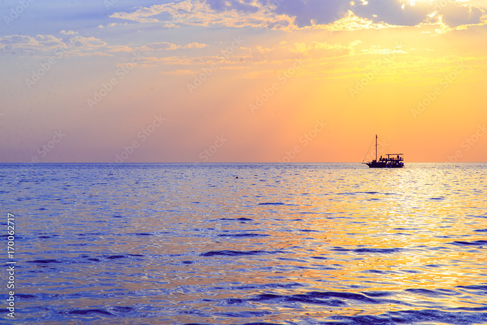 orange sunset on the sea with boat