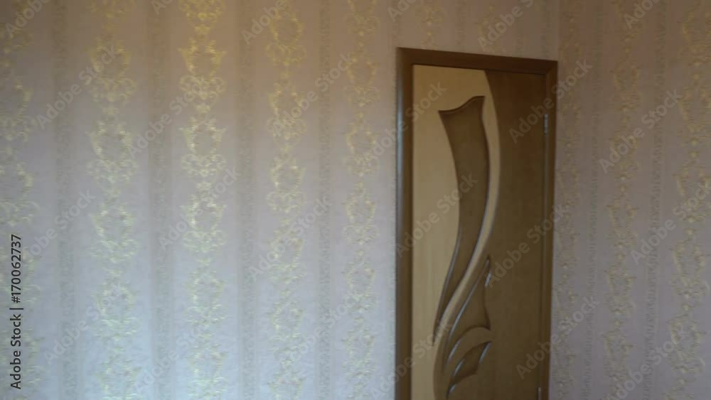 the interior of the room after renovation, the beautiful brown door and gold Wallpaper. the interior of the room after renovation, the beautiful brown door and gold Wallpaper.
