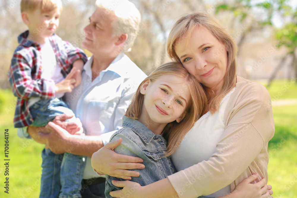 Cute happy children with grandparents in spring park on sunny day Cute happy children with grandparents in spring park on sunny day