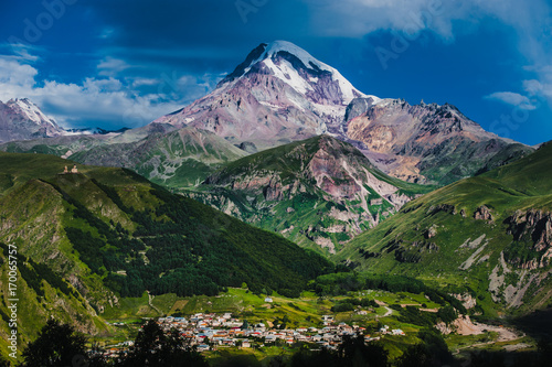 Mount Kazbek view from Stepantsminda town in Georgia in good weather for climbing. It is a dormant stratovolcano and one of the major mountains of the Caucasus. photo