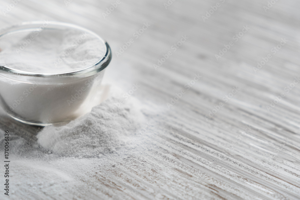 Glass bowl of baking soda. Spoonful of bicarbonate. Baking soda, Sodium bicarbonate, NaHCO3 Glass bowl of baking soda. Spoonful of bicarbonate. Baking soda, Sodium bicarbonate, NaHCO3