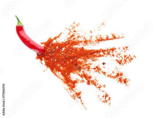 Canvas Print Red hot pepper bursting with chili powder isolated on white