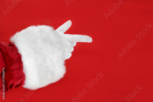 Santa Claus hand against red background