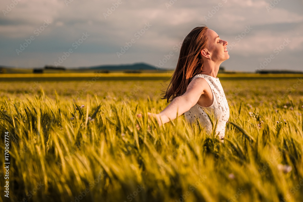 Beautiful woman in white dress on golden yellow wheat field Beautiful woman in white dress on golden yellow wheat field