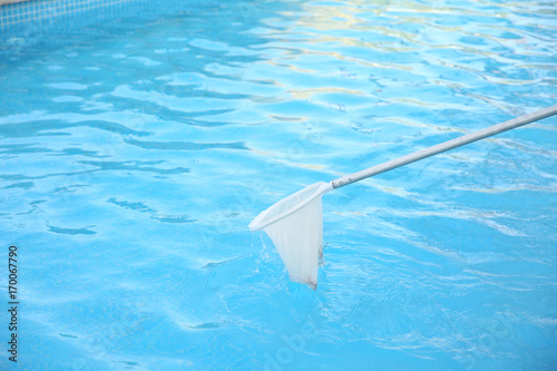 Cleaning swimming pool with net