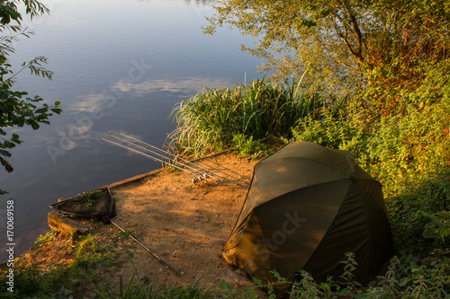Carp Angler scenic landscape overlooking lake at Dawn