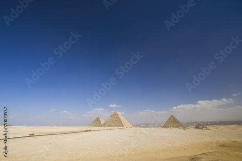 Great Giza pyramids and blue sky with clouds