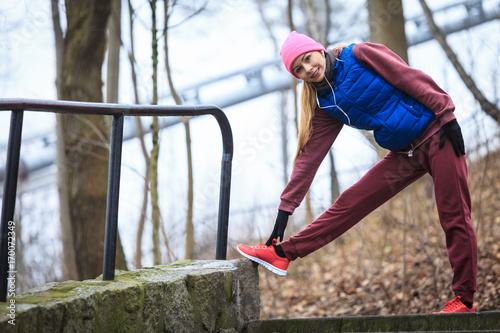 Woman wearing sportswear exercising outside during autumn © Voyagerix