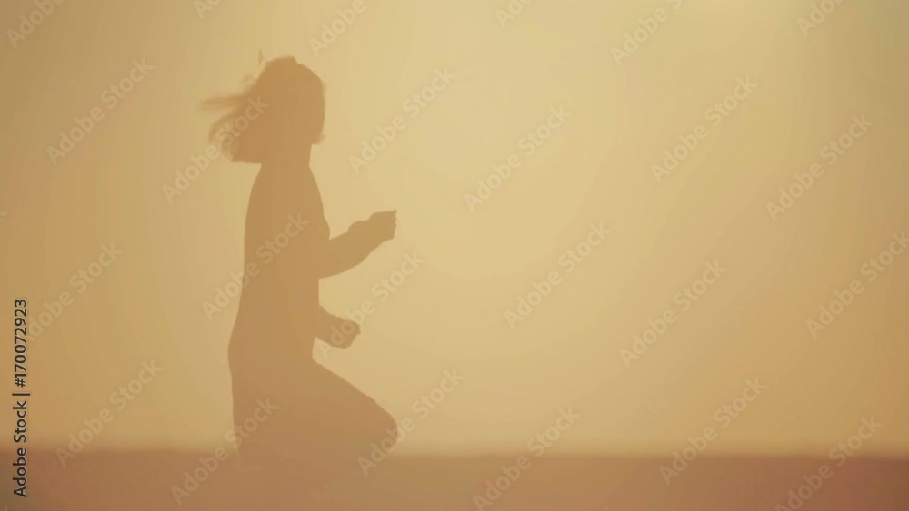 Portrait of silhouette of woman on nature in the field. Silhouette of running and dancing girl in a field at sunset.
Portrait of silhouette of woman on nature in the field. Silhouette of running and dancing girl in a field at sunset.