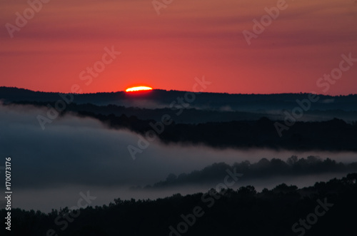 The start of a colorful sunrise over the foggy valleys near Heflin, Alabama, USA photo