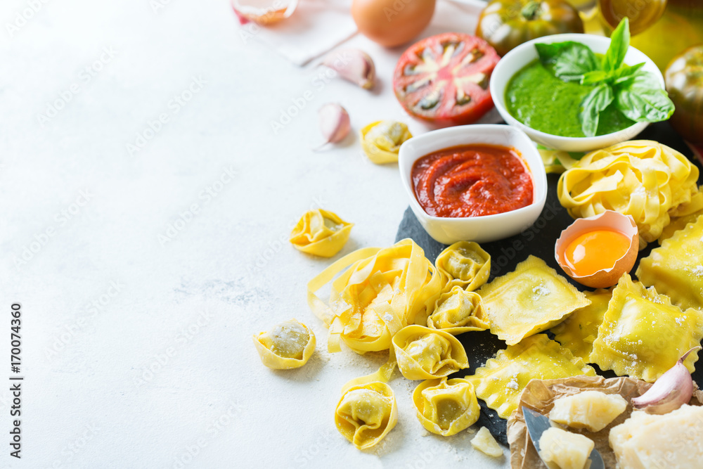 Italian food and ingredients, ravioli pasta spaghetti pesto tomato sauce Italian food and ingredients, ravioli pasta spaghetti pesto tomato sauce
