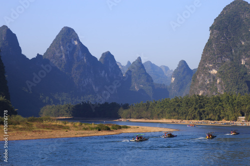 Tourist boats travels the magnificent scenic route along the Li river from Guilin to Yangshuo.