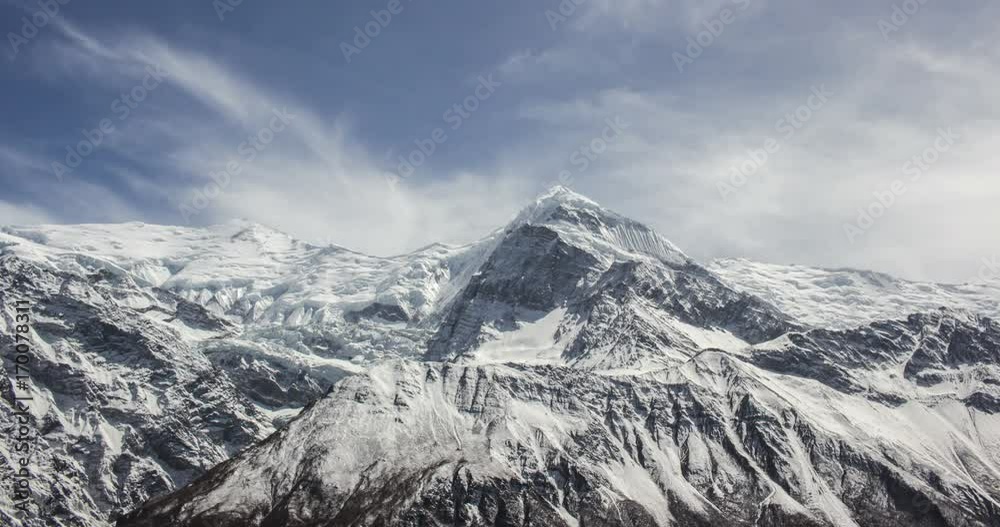 Clouds moving over peaks of snow-capped mountains Clouds moving over peaks of snow-capped mountains