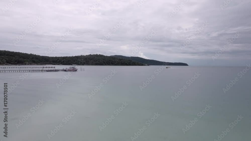 drone view : flying towards the speedboat reaching wooden pier drone view : flying towards the speedboat reaching wooden pier