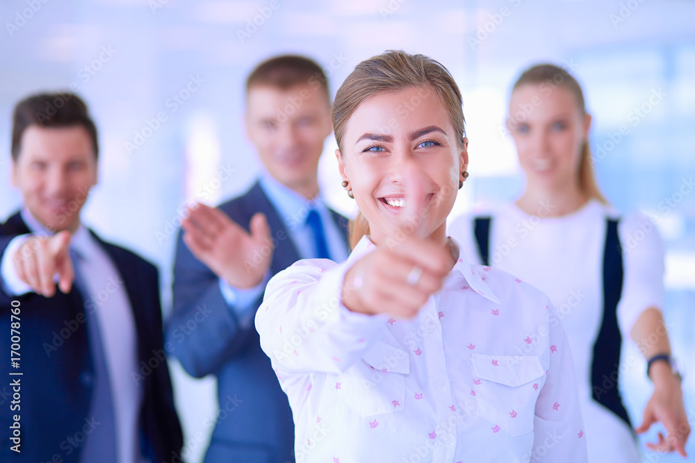 Happy business team showing thumbs up in office Happy business team showing thumbs up in office