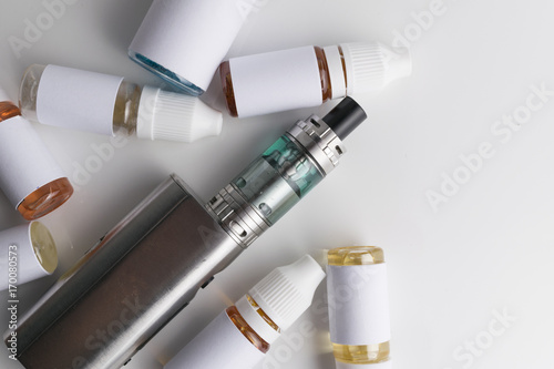 Isolated e liquid bottles and electronic cigarette, e cig for vape devices over a white background