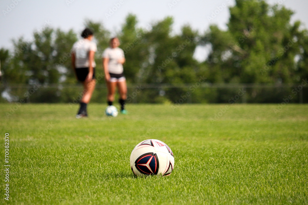 Women Playing Soccer Kicking Soccer Ball on Green Grass Turf Women Playing Soccer Kicking Soccer Ball on Green Grass Turf