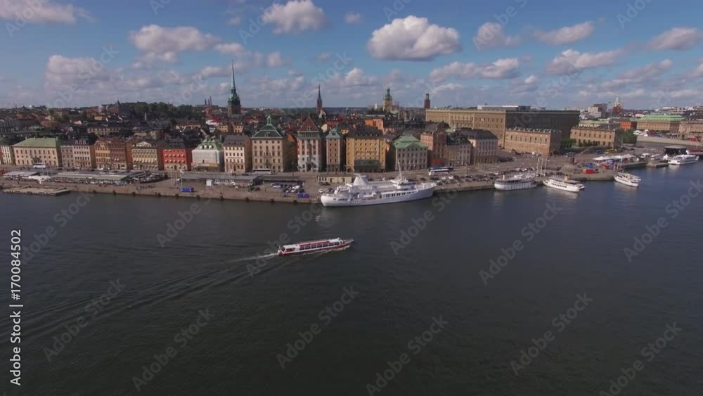 Aerial view of Stockholm city Old Town. Drone shot flying towards city buildings in Gamla stan, Stockholm, Sweden. Flying over the mast on a ship, ferry boat passing by Aerial view of Stockholm city Old Town. Drone shot flying towards city buildings in Gamla stan, Stockholm, Sweden. Flying over the mast on a ship, ferry boat passing by