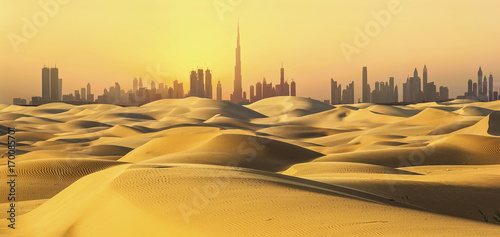 Dubai skyline in desert at sunset. photo