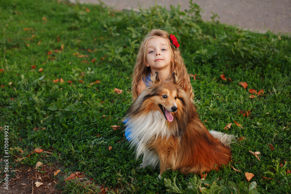 Little girl with a dog Sheltie
