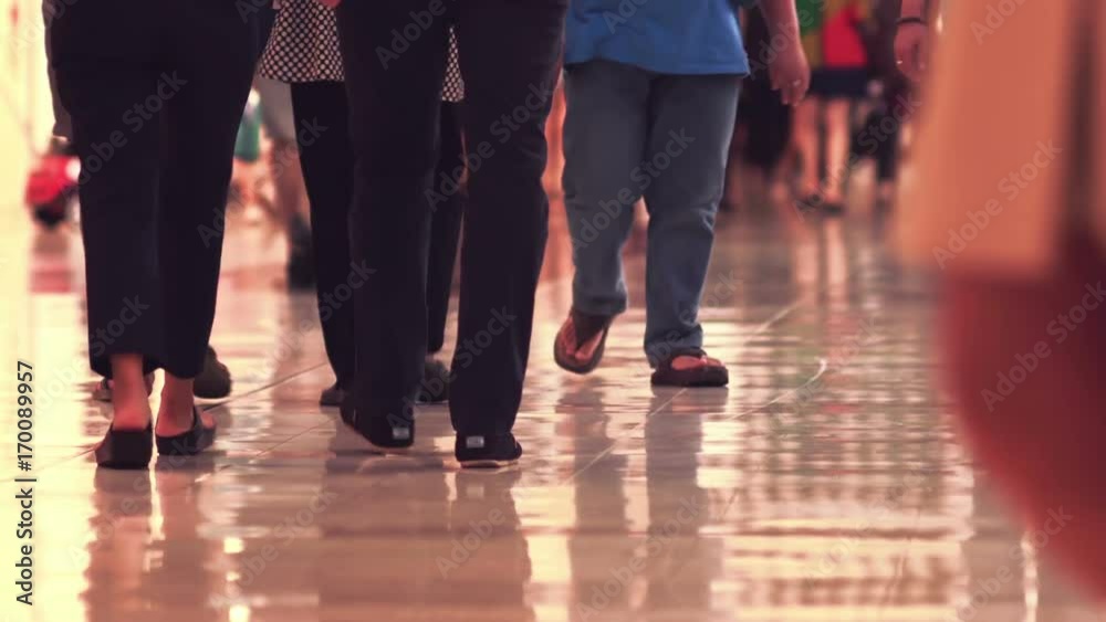 Crowd of shoppers walking and shopping in a busy shopping mall Crowd of shoppers walking and shopping in a busy shopping mall