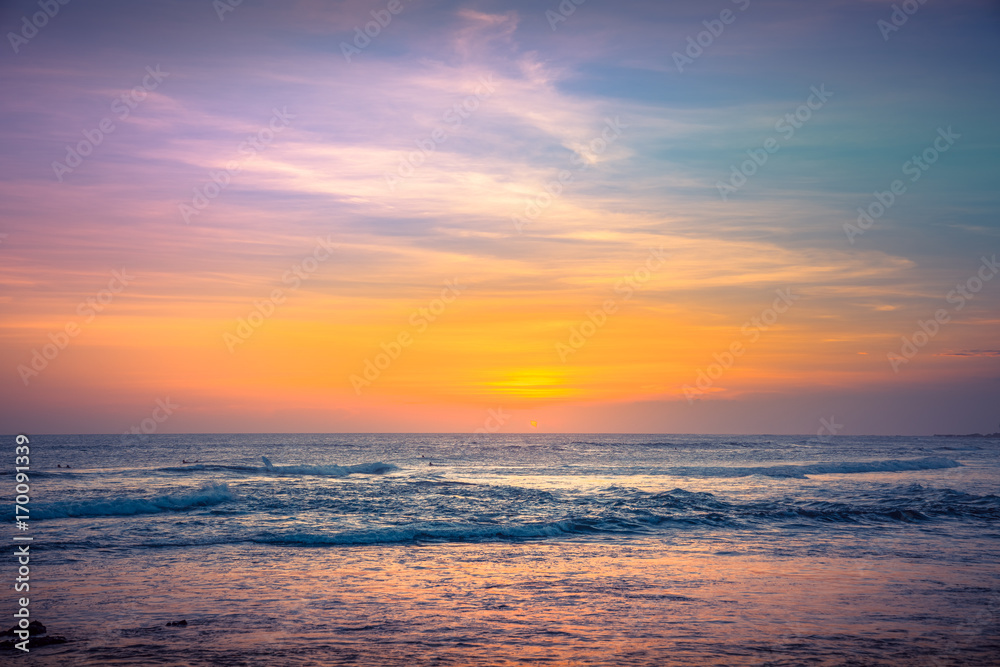 Amazing Beautiful sky and long exposure Waves for Background. Colorful Ocean Background at Sunset Time. Panorama of Tropical Sunset Beach on the ocean. Surfing Beach with Surfers on the Horizon. View