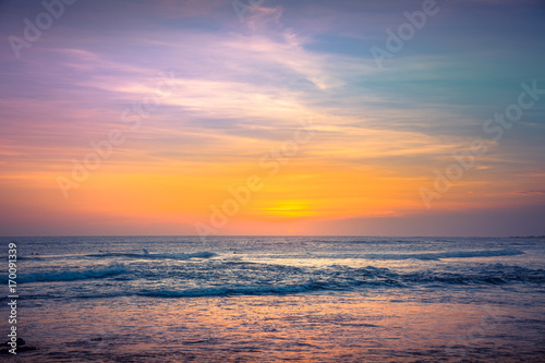Amazing Beautiful sky and long exposure Waves for Background. Colorful Ocean Background at Sunset Time. Panorama of Tropical Sunset Beach on the ocean. Surfing Beach with Surfers on the Horizon. View