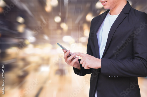 Business man using smart phone on futuristic technology connection shape over the motion interior space background