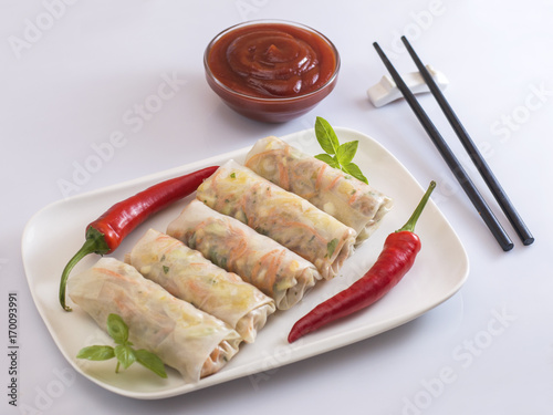 Fresh vegetables spring rolls on white plate. 