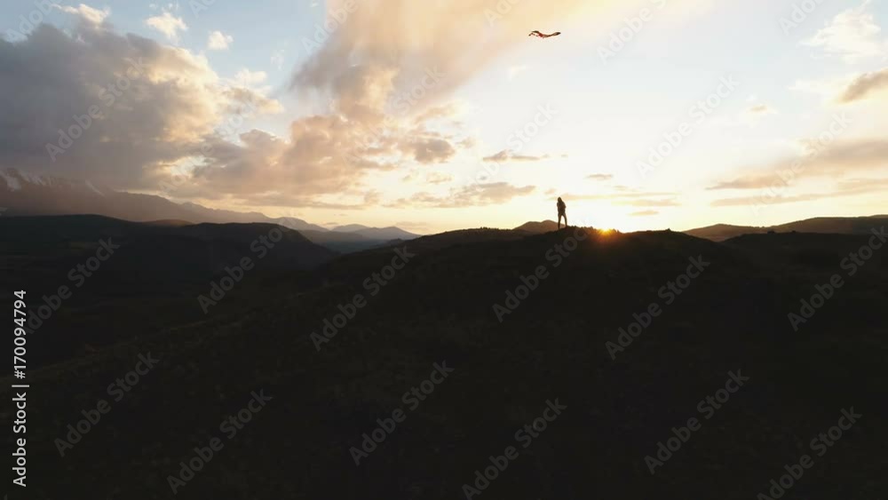 Silhouette Of woman flying kite at sunset time. 4k slow motion Silhouette Of woman flying kite at sunset time. 4k slow motion