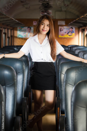 Portrait of thai adult student university uniform on train transport