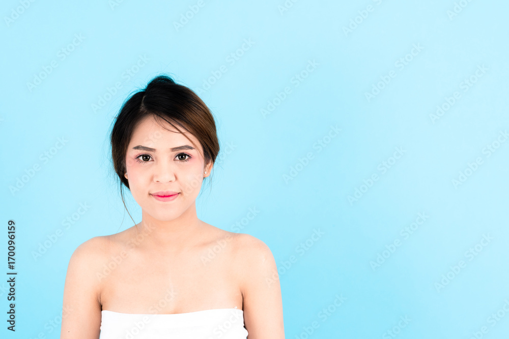 Asian young beautiful confidence woman smiling portrait over blue background Asian young beautiful confidence woman smiling portrait over blue background
