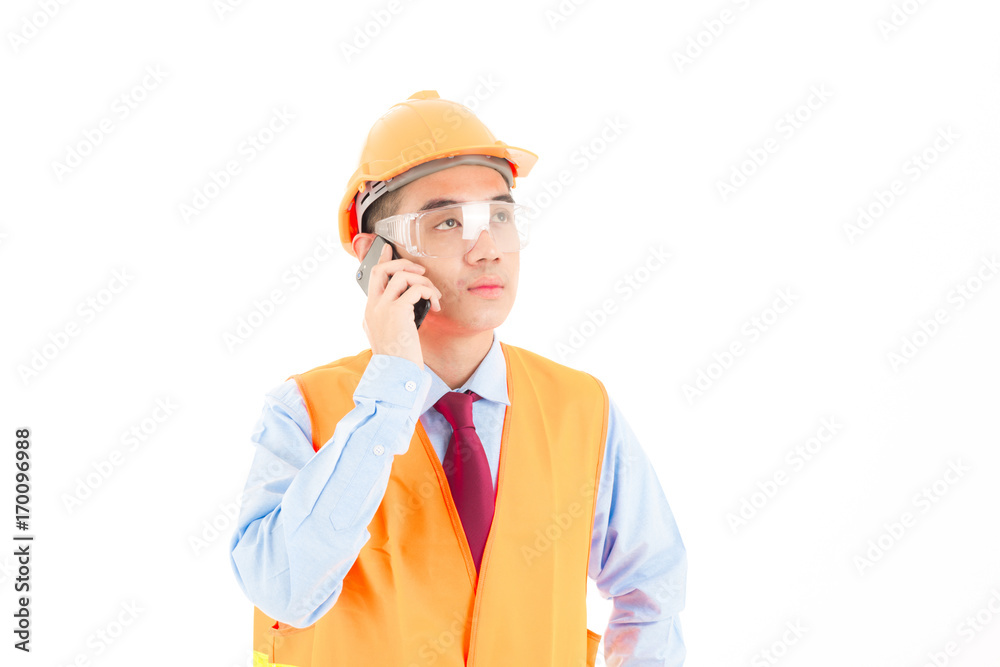 Young confident asian man, orange safety hat, orange safety jacket, safety glass, red tie, blue shirt on white using smart device. Young confident asian man, orange safety hat, orange safety jacket, safety glass, red tie, blue shirt on white using smart device.