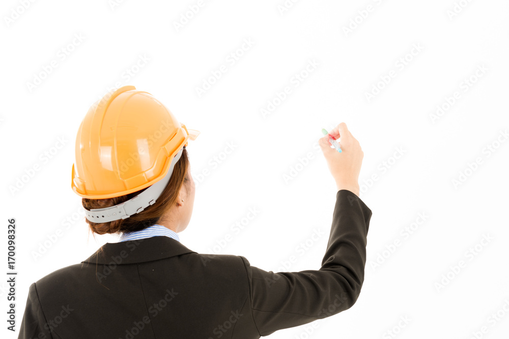 Young confident asian woman, orange safety hat, black suit, blue shirt on white using pen.