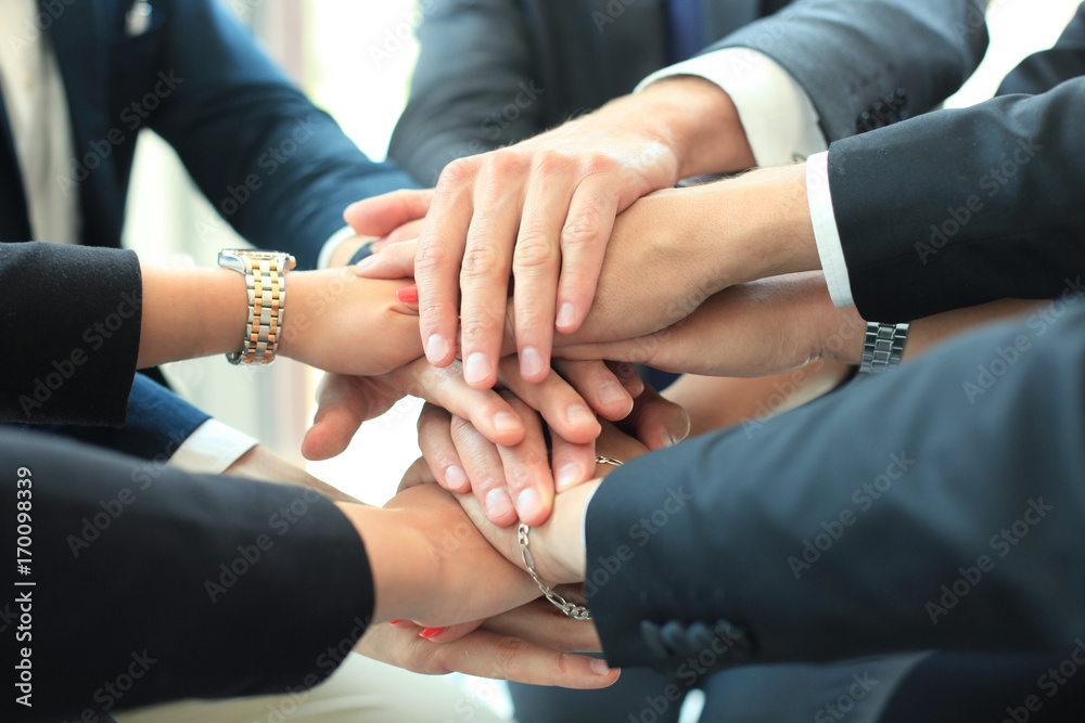 Group of businessman team touching hands together. Selective focus.