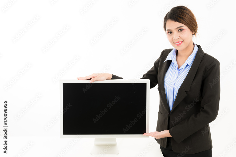 Young attractive confident Asian female business woman in suit blue shirt presenting with monitor in white background. Young attractive confident Asian female business woman in suit blue shirt presenting with monitor in white background.