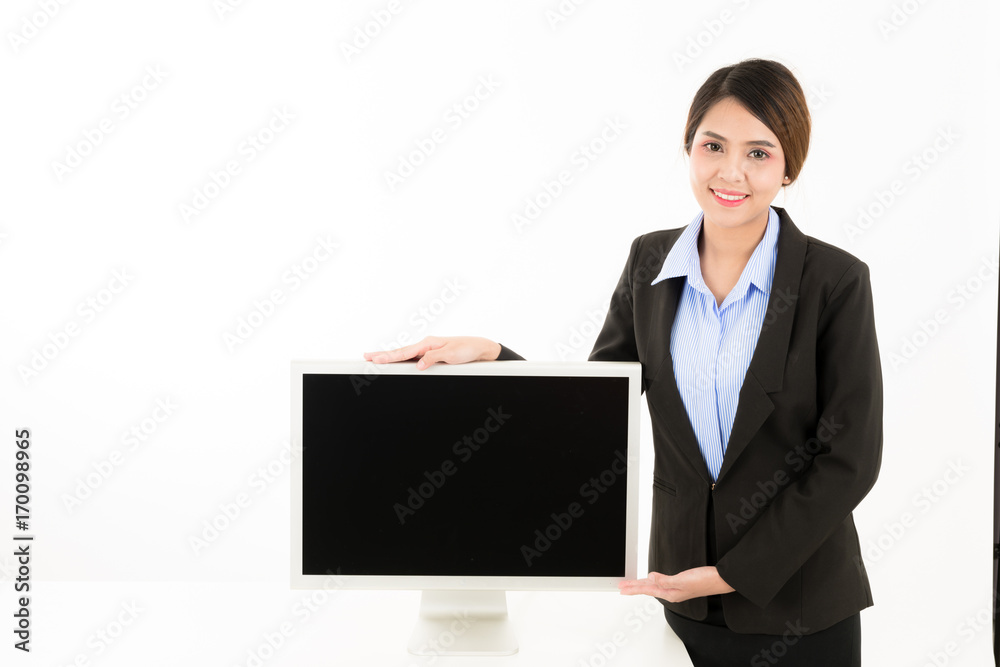 Young attractive confident Asian female business woman in suit blue shirt presenting with monitor in white background. Young attractive confident Asian female business woman in suit blue shirt presenting with monitor in white background.