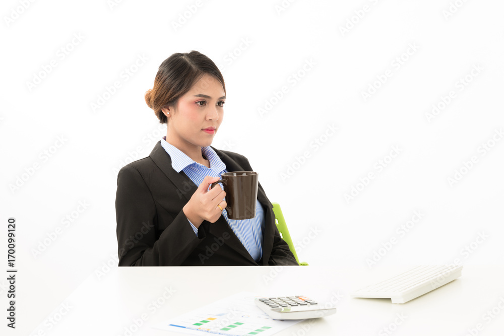 Young attractive confident Asian female business woman in suit blue shirt sit on desk work in white background. Young attractive confident Asian female business woman in suit blue shirt sit on desk work in white background.