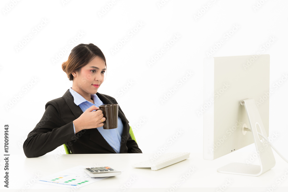 Young attractive confident Asian female business woman in suit blue shirt sit on desk work in white background. Young attractive confident Asian female business woman in suit blue shirt sit on desk work in white background.