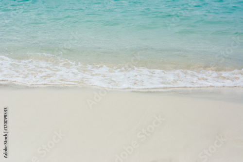 Beach Background. Close up ocean on sandy beach Background. Tide wave of sea on the sand beach in Phuket Thailand travel.