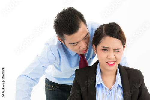 Young confident Asian office employee business man whisper close to attractive Asian office woman ear.