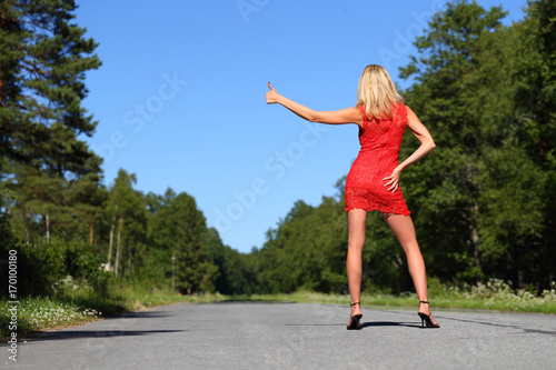 woman and hitchhiking on the road © Andrew