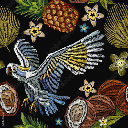 Embroidery parrot, palm tree leaves, pineapple, coconut tropical seamless pattern. Fashionable embroidery tropical parrot, summer background. Template for design of clothes